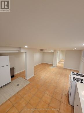 Toronto (Oakwood Village) apartment for rent - A kitchen with a white fridge and a white stove.