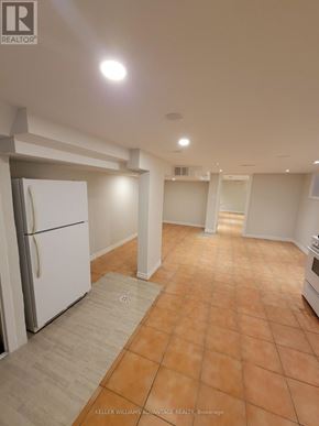 Toronto (Oakwood Village) apartment for rent - A kitchen with a white fridge and orange tiled floor.