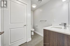 Burlington (Brant) townhouse for rent - A bathroom with a white door, a white sink, and a white toilet.
