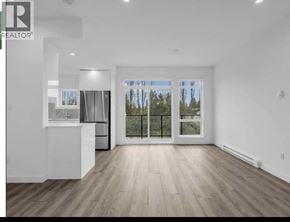 Richmond townhouse for rent - A spacious room with wooden flooring and a large window overlooking a fence.