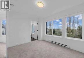 Richmond townhouse for rent - A spacious room with a large window overlooking a natural landscape.