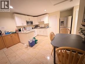 Vancouver apartment for rent - A kitchen with a table and chairs in the foreground.