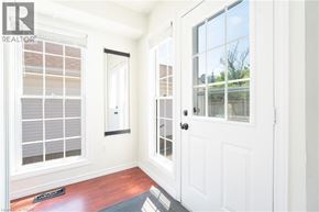Kitchener apartment for rent - A white door with a black handle is in the middle of a room.