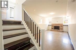 Kitchener apartment for rent - A living room with a fireplace and a staircase.