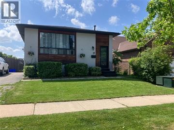 Stoney Creek apartment for rent - A house with a brown roof and a green lawn in front.