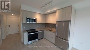 Milton (Cb Cobban) condo for rent - A kitchen with wooden cabinets and stainless steel appliances.