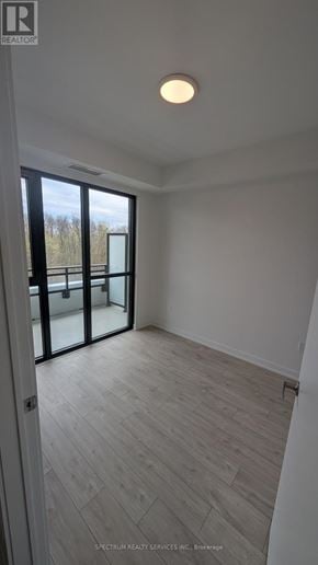 Milton (Cb Cobban) condo for rent - A room with a wooden floor and a sliding glass door.
