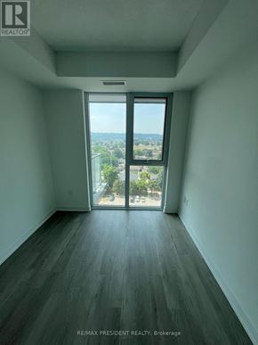 Hamilton (Riverdale) condo for rent - A room with a view of the city through a large window.