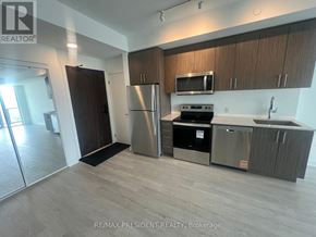 Hamilton (Riverdale) condo for rent - A modern kitchen with stainless steel appliances and wooden cabinets.