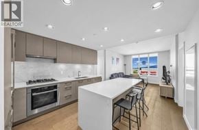 Vancouver apartment for rent - A modern kitchen with a large island and stainless steel appliances.