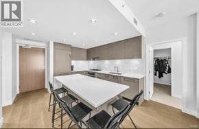 Vancouver apartment for rent - A modern kitchen with a dining table and chairs.