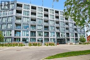 Kitchener condo for rent - A large, modern building with many windows and balconies.