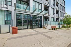 Kitchener condo for rent - The image shows a modern building with a glass entrance and a sign that reads "REALTOR".