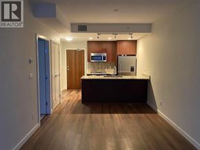 Richmond apartment for rent - A kitchen with a refrigerator, microwave, and oven.