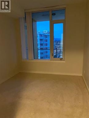 Richmond apartment for rent - A room with a window overlooking a cityscape.