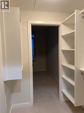 Richmond apartment for rent - A white closet with shelves and an open door.