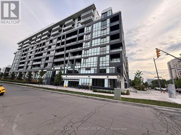 Toronto (Bayview Village) condo for rent - A modern multi-story building with a glass facade is the main focus of the image.