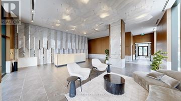 Toronto (Bayview Village) condo for rent - A modern living room with a white sofa set and a black coffee table.