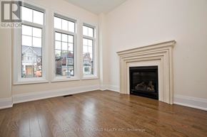 Toronto (Hillcrest Village) apartment for rent - A room with a fireplace and wood flooring.