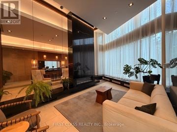 Toronto (Thorncliffe Park) condo for rent - A modern living room with a large couch and a television.