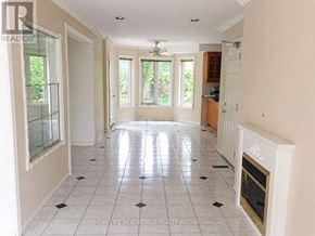 Toronto (Hillcrest Village) apartment for rent - A room with a tiled floor and a staircase in the background.