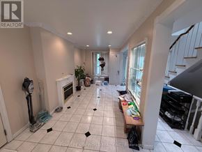 Toronto (Hillcrest Village) apartment for rent - A room with a white tiled floor and a fireplace.