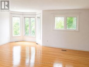 Toronto (Hillcrest Village) apartment for rent - A kitchen with a table and chairs in front of a window.