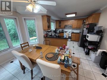 Toronto (Hillcrest Village) apartment for rent - A kitchen with a table and chairs in front of a window.