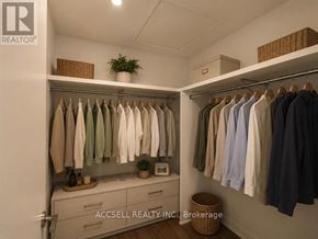 Vaughan (Vaughan Corporate Centre) condo for rent - A closet with clothes hanging and a basket on the floor.