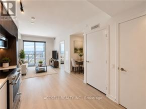 Vaughan (Vaughan Corporate Centre) condo for rent - A spacious living room with a kitchen area and a dining table.