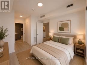 Vaughan (Vaughan Corporate Centre) condo for rent - A bedroom with a large bed, a nightstand, and a plant on the side table.