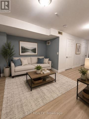 Mississauga (Churchill Meadows) apartment for rent - A living room with a couch, coffee table, and a painting on the wall.