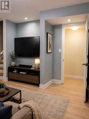 Mississauga (Churchill Meadows) apartment for rent - A living room with a flat screen TV and a wooden cabinet.