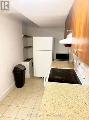 Mississauga (Churchill Meadows) apartment for rent - A kitchen with a white fridge, microwave, and oven.