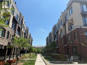 Mississauga (Erin Mills) townhouse for rent - A row of modern apartment buildings with a clear blue sky above.