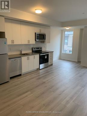 Mississauga (Erin Mills) townhouse for rent - A kitchen with white cabinets and a wooden floor.