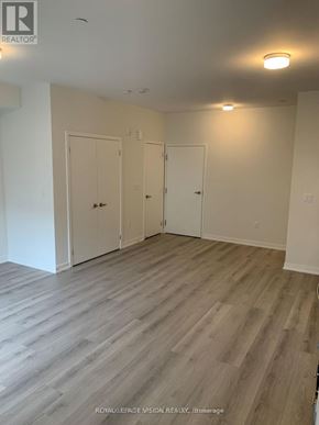 Mississauga (Erin Mills) townhouse for rent - A room with wood flooring and white walls.