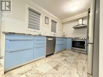 Mississauga (Streetsville) townhouse for rent - A kitchen with blue cabinets and a tiled floor.