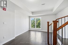 Toronto (Weston) townhouse for rent - A spacious room with a staircase leading to the second floor.