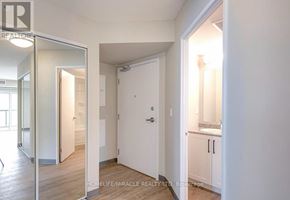 Kitchener multi-family for rent - A white room with a doorway leading to another room.