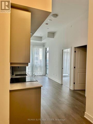 Oakville (Wm Westmount) condo for rent - A modern kitchen with wooden cabinets and a countertop.