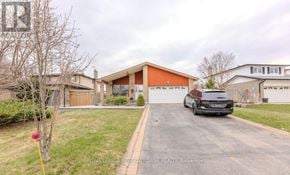 Milton (Tm Timberlea) apartment for rent - A black car is parked in front of a house with a red garage door.