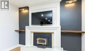 Milton (Tm Timberlea) apartment for rent - A fireplace with a TV above it in a room.