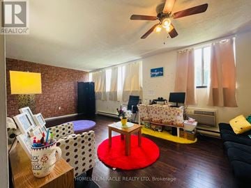 Guelph (Willow West/Sugarbush/West Acres) condo for rent - A living room with a red rug and a ceiling fan.