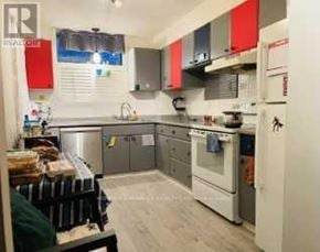 Guelph (Willow West/Sugarbush/West Acres) condo for rent - A kitchen with white appliances and red cabinets.