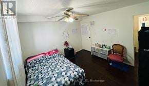 Guelph (Willow West/Sugarbush/West Acres) condo for rent - A bedroom with a bed, dresser, and chair.