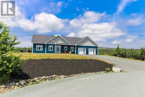 Torbay apartment for rent - A blue house with a gravel driveway in front.