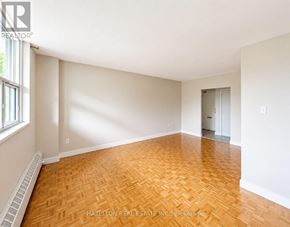Toronto (Victoria Village) condo for rent - A room with a wooden floor and white walls.