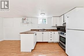 Whitby (Williamsburg) apartment for rent - A kitchen with white cabinets and a brown countertop.