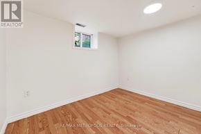 Whitby (Williamsburg) apartment for rent - A room with wooden flooring and white walls.